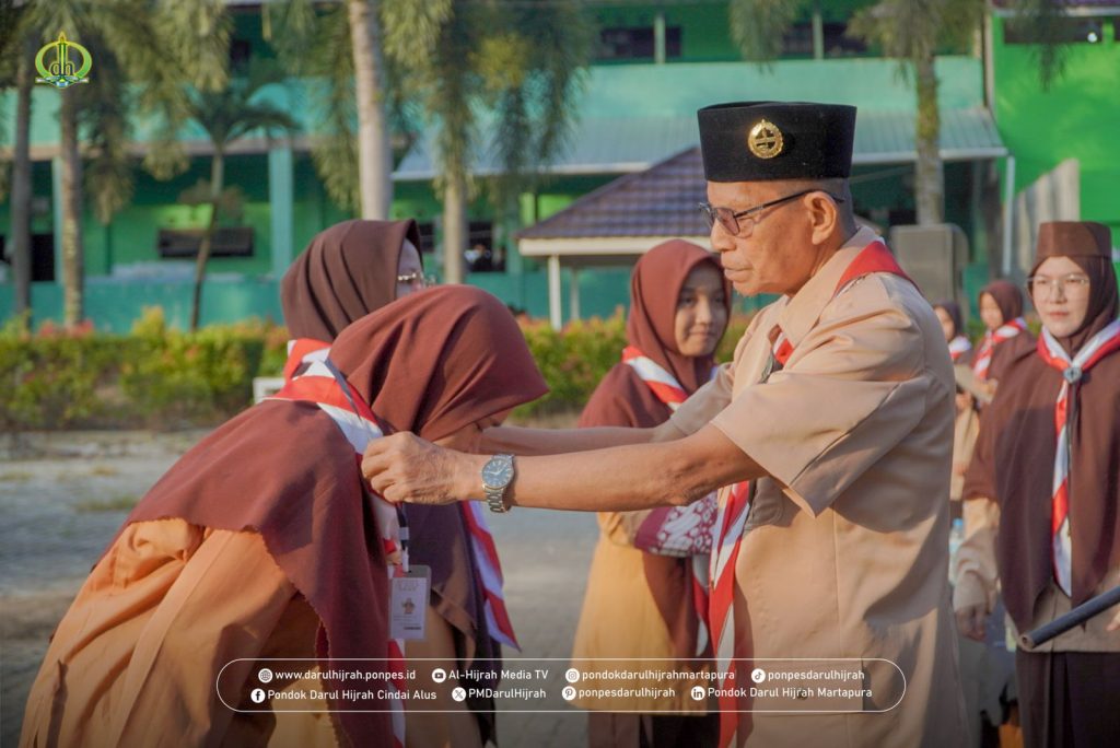pengalungan tanda peserta dan panitia oleh pimpinan pondok darul hijrah cindai alus pada kegiatan pembukaan perkemahan pramuka 2025